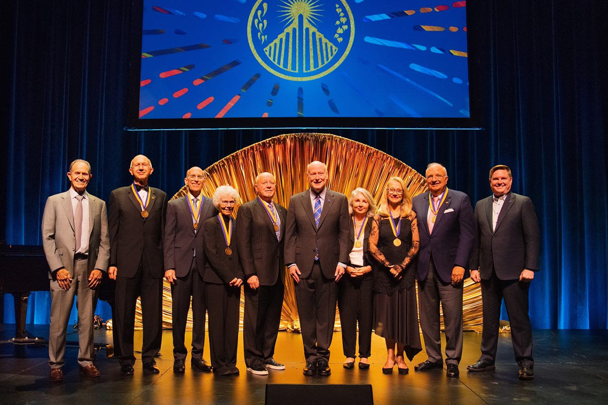 UC Irvine leadership and honorees at the 2025 Medal ceremony. Pictured, from left: UC Irvine Foundation Board of Trustees Chair Gary Singer ’74; Goran Matijasevic, M.S. ’85, Ph.D. ’91; Paul Butterworth ’74, M.S. ’81; Jo Butterworth ’75; Jimmy Peterson; Chancellor Howard Gillman; Sheila Peterson; Julie Hill; James Irvine Swinden and Vice Chancellor Brian Hervey. Christopher Todd Studios